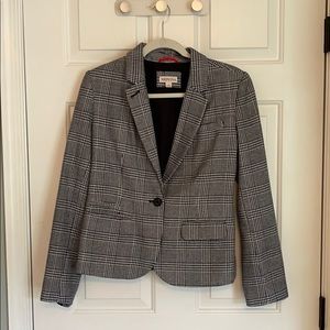 Black and white women’s suit jacket.